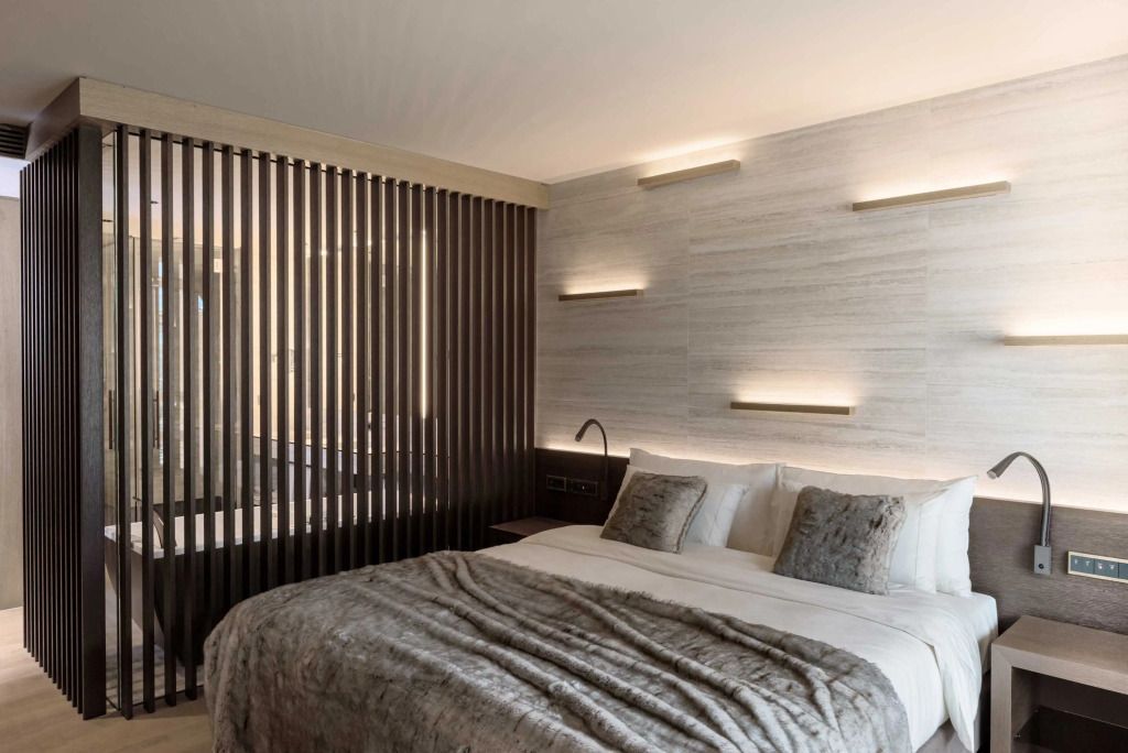 Elegantes Schlafzimmer mit luxuriöser Bettwäsche und modernen Wandlampen