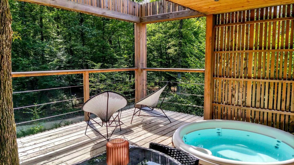 Terrasse mit Panorama-Waldblick, modernen Stühlen und Whirlpool