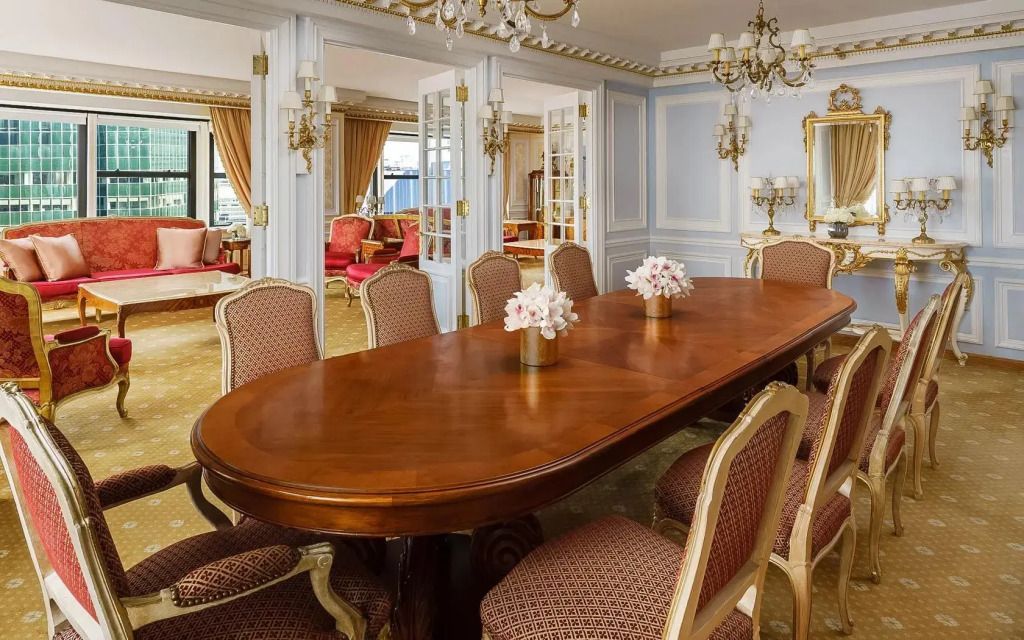 Elegantes Esszimmer mit großem Holztisch und reich dekorierten Stühlen im Imperial Suite