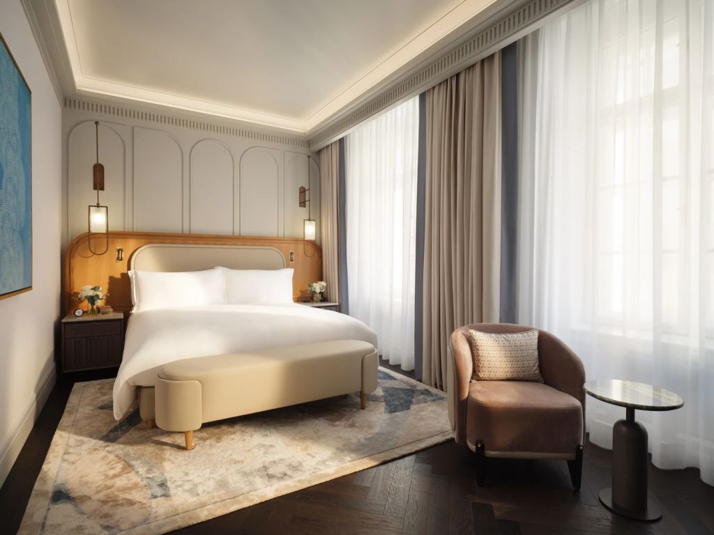 Geräumiges Zimmer mit einem großen Bett und eleganten Vorhängen