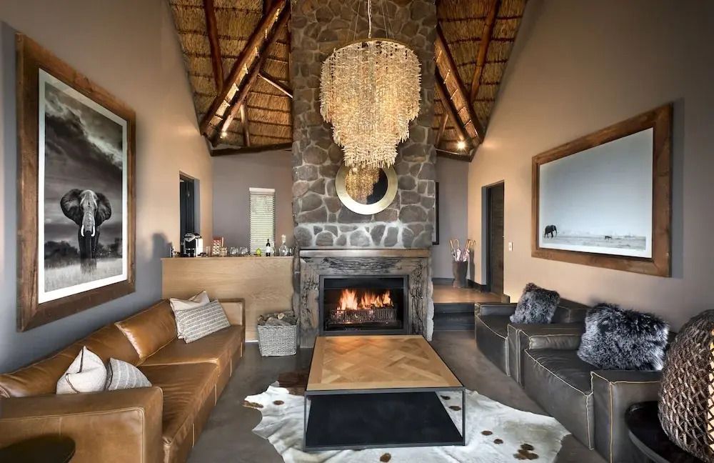 Gemütliche Lounge mit Kamin und stilvollem Kronleuchter aus Naturmaterialien