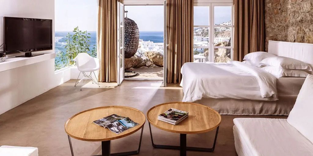 Suite mit Meerblick, modern eingerichtet mit hellen Möbeln und großen Fenstern.