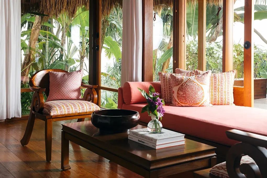 Gemütliche Lounge-Ecke mit edlen Kissen und Holzdetails in der Villa
