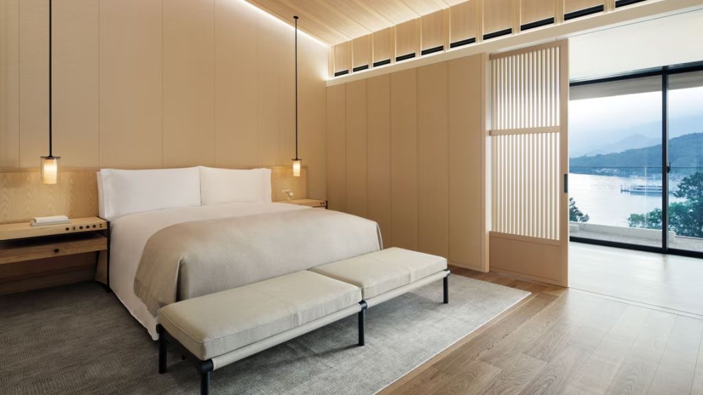 Elegante Doppel-Suite mit großem Doppelbett und Sitzbank im Ritz-Carlton Nikko