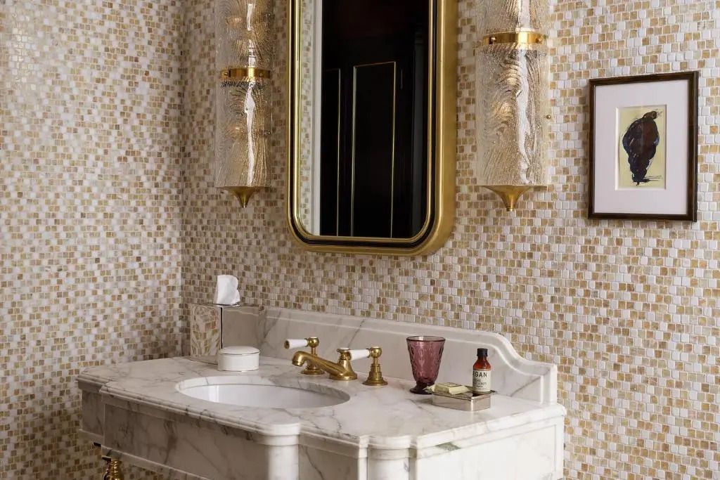 Luxuriöses Badezimmer mit Marmordetails und goldenen Akzenten im NoMad London Hotel