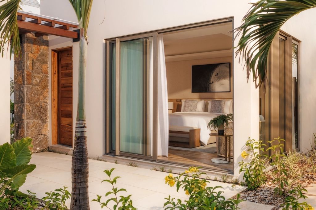 Moderne Suite mit offenem Fenster und Poolblick in eleganter Umgebung