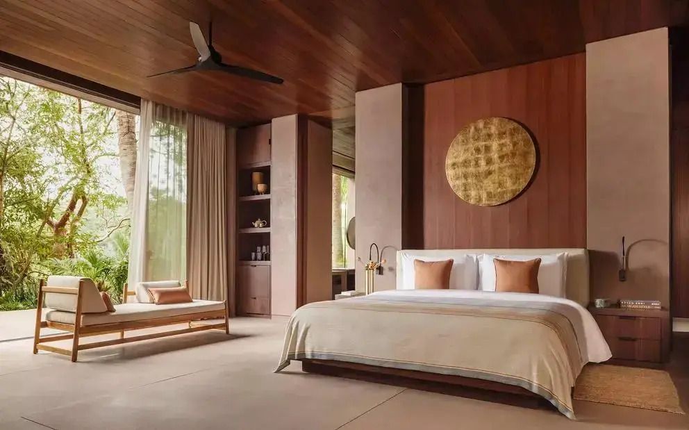 Elegantes Schlafzimmer in warmen Tönen mit großem Bett und Kunstwerk an der Wand