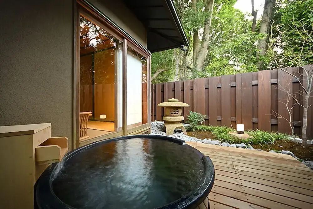 Privater Gartenbereich mit kleinem Holz-Whirlpool und Laterne