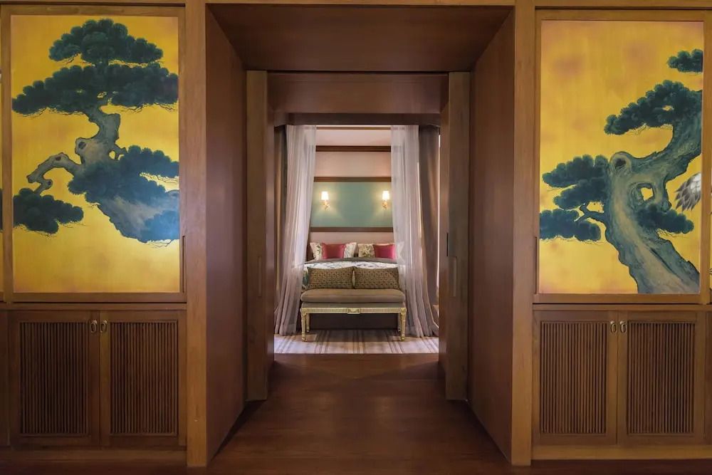 Eleganter Eingang mit kunstvoll verzierten Schiebetüren zum Schlafzimmer der Suite.