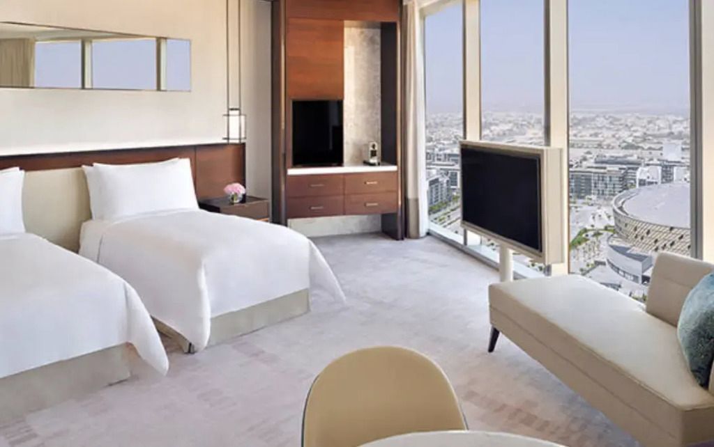 Elegantes Doppelzimmer mit Einzelbetten und Panoramablick auf die Stadt.