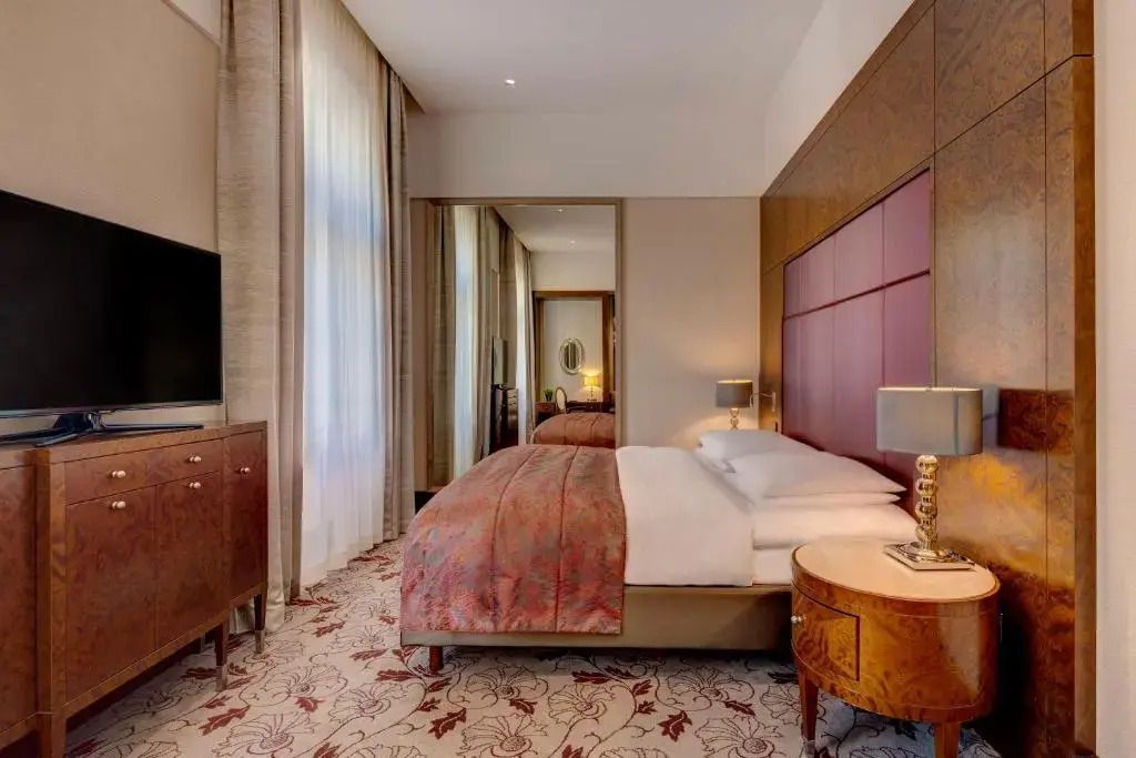 Modernes Deluxe Zimmer mit gemütlichem Bett und stilvollen Möbeln im Hotel