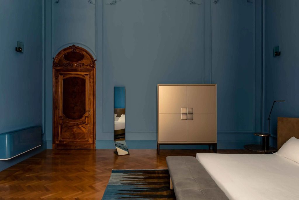 Elegantes Zimmer mit antiker Tür und modernem Schrank.