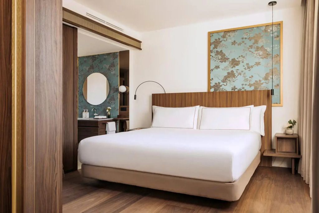 Großes Schlafzimmer der Master Doppel Suite mit Doppelbett und dekorativer Wandkunst