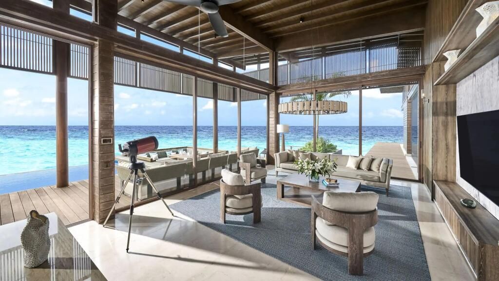 Luxuriöses Wohnzimmer mit großen Fenstern und Meerblick in einer Überwasser-Residenz