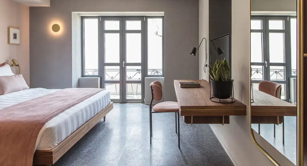 Helles Zimmer mit Schreibtisch und Balkonblick