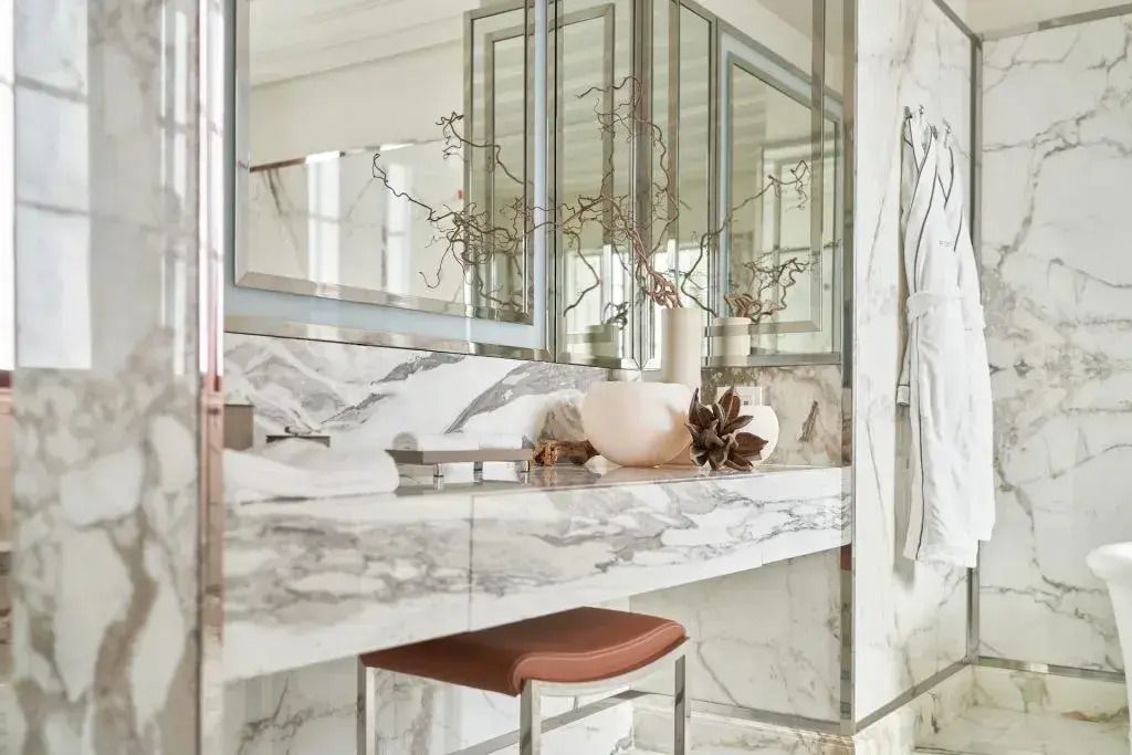 Modernes Badezimmer mit marmorierter Oberfläche und eleganter Dekoration.
