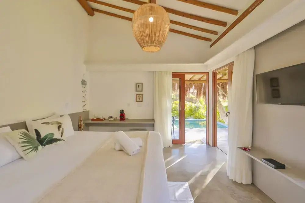 Lichtdurchflutetes Zimmer mit Blick auf den Garten und den Pool im Bungalow