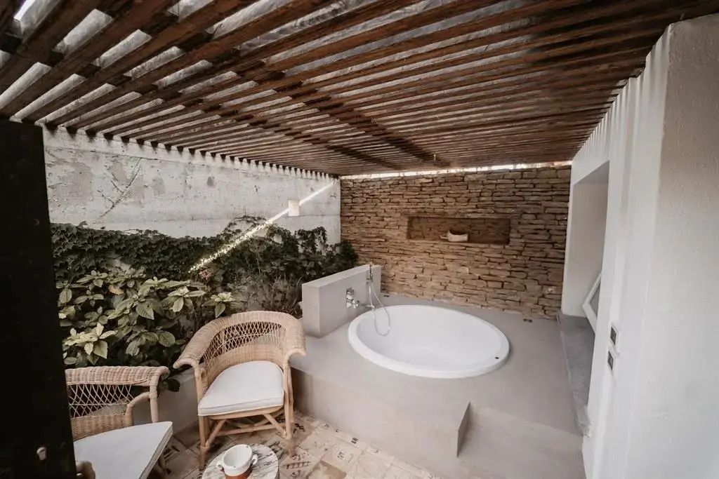 Privater Außenbereich mit Whirlpool unter Pergola