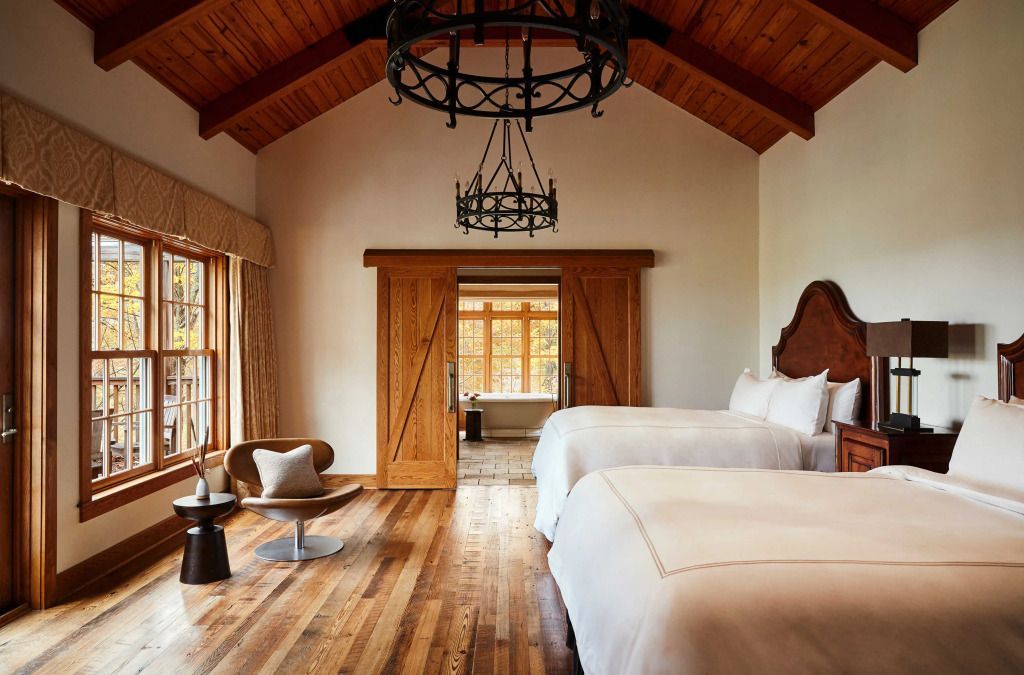 Gemütliches Schlafzimmer mit Holzbalkendecke und zwei Doppelbetten