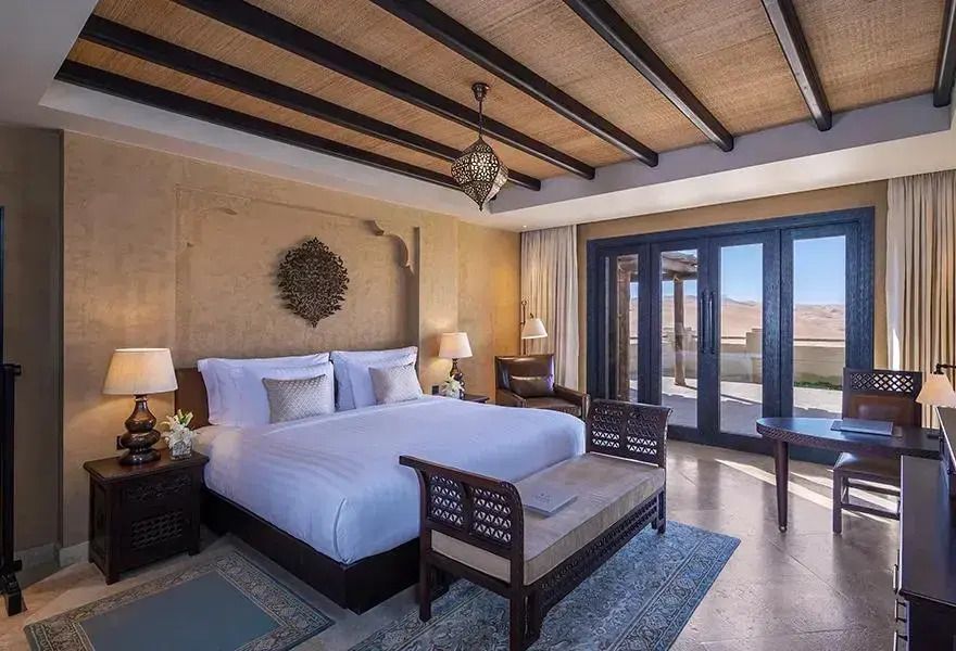 Luxuriöses Schlafzimmer mit Kingsize-Bett und Ausblick auf die Wüste