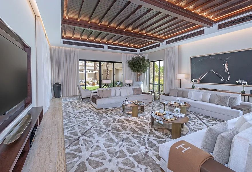 Elegantes Wohnzimmer mit großen Sofas und stilvoller Beleuchtung im Wüstenresort.