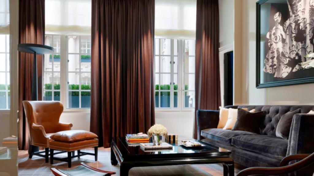 Luxuriöses Wohnzimmer mit großen Fenstern und eleganter Einrichtung.