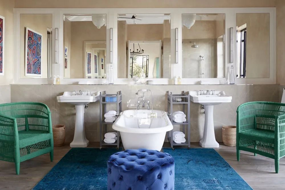 Luxuriöses Badezimmer mit freistehender Badewanne und großen Spiegeln