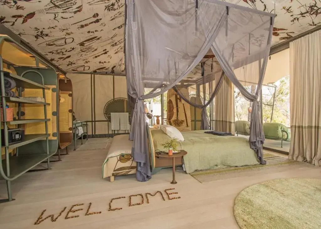 Luxuriöses Schlafzimmer mit Baldachinbett und kunstvoller Deckengestaltung im Saseka Tented Camp.