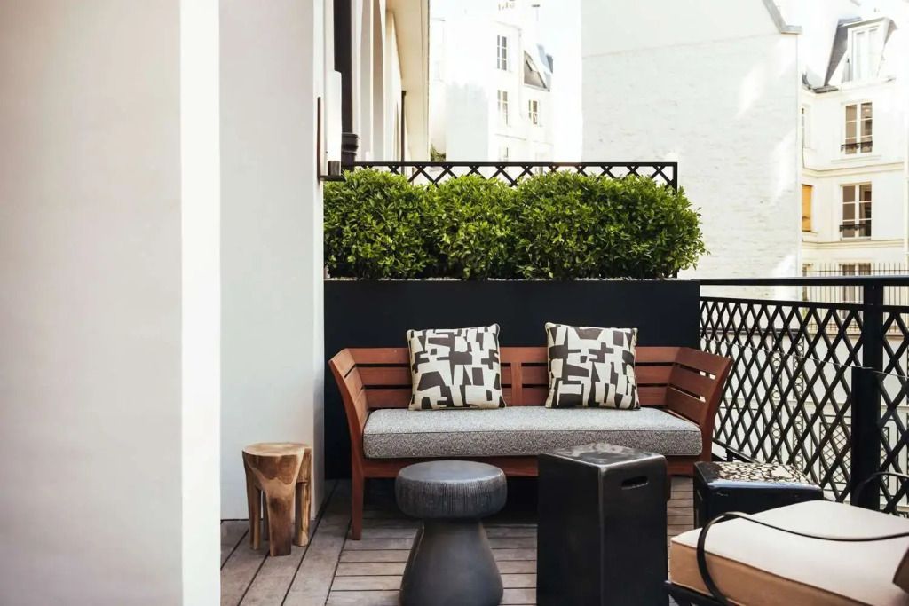 Gemütliche Terrasse mit Sitzbank, Beistelltischen und Pflanzen