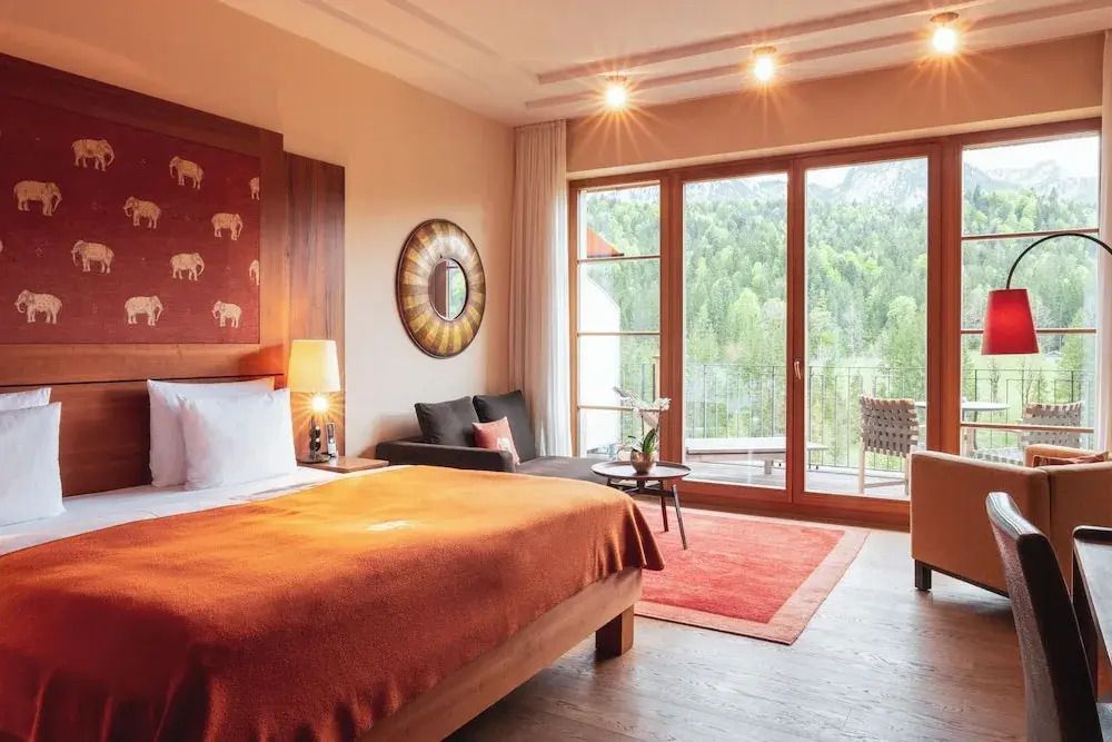 Gemütliches Doppelzimmer im Hotel mit großer Glasfront und Balkon