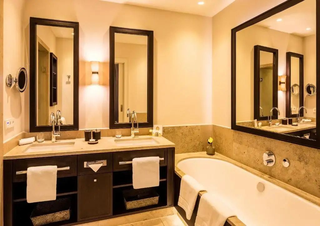 Luxuriöses Badezimmer mit Badewanne und doppeltem Waschbecken im Deluxe Doppelzimmer