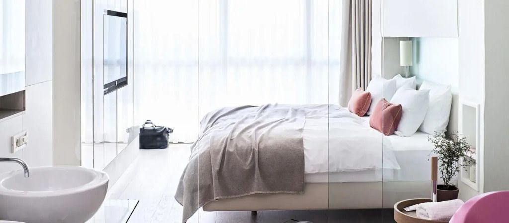 Helles Schlafzimmer mit großem Bett und weichem Bettzeug.