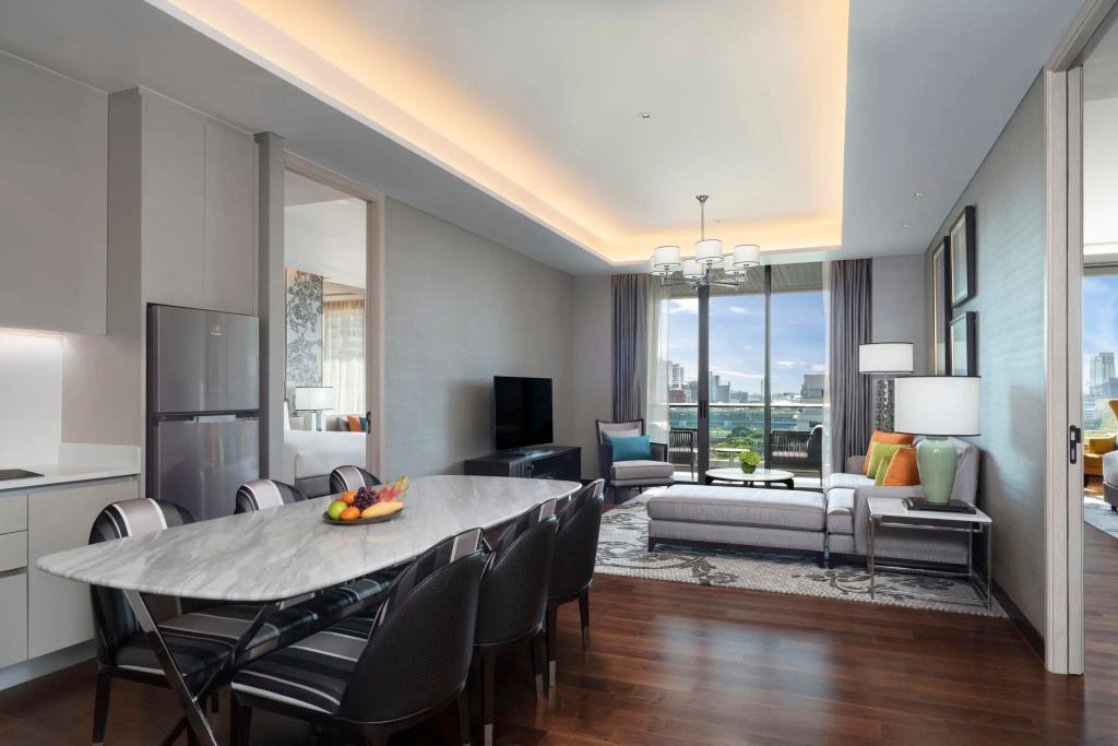 Wohnbereich einer Suite mit Essbereich und Blick auf die Stadt