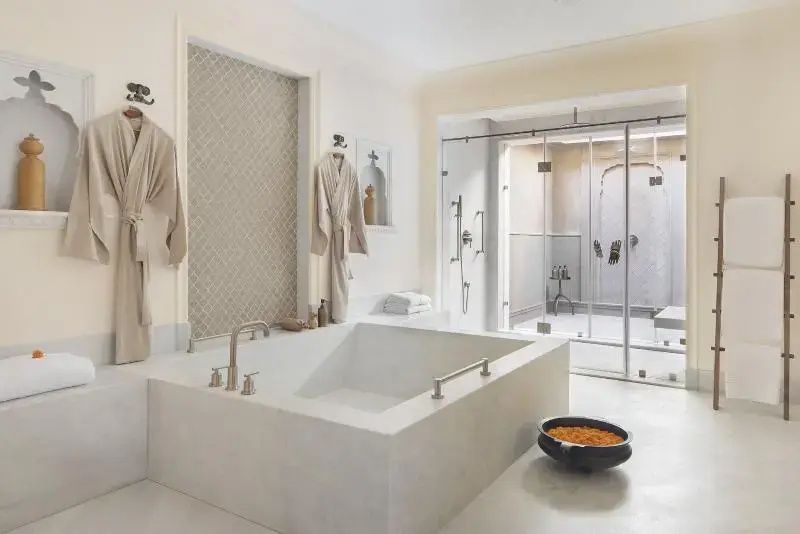 Geräumiges Badezimmer mit freistehender Badewanne und großer Dusche
