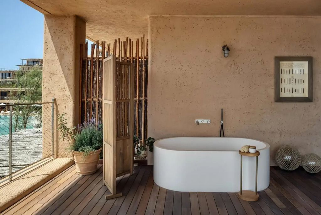 Freistehende Badewanne auf privater Terrasse mit natürlichem Flair