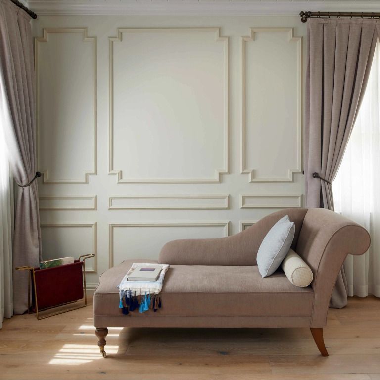 Elegante Chaiselongue in schlichter Umgebung mit feierlicher Wandgestaltung