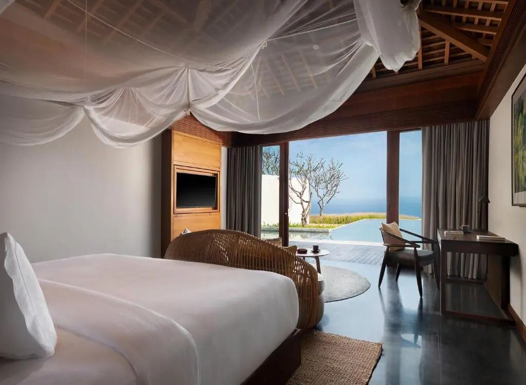 Geräumiges Schlafzimmer mit Himmelbett und Blick auf das Meer und den privaten Pool.