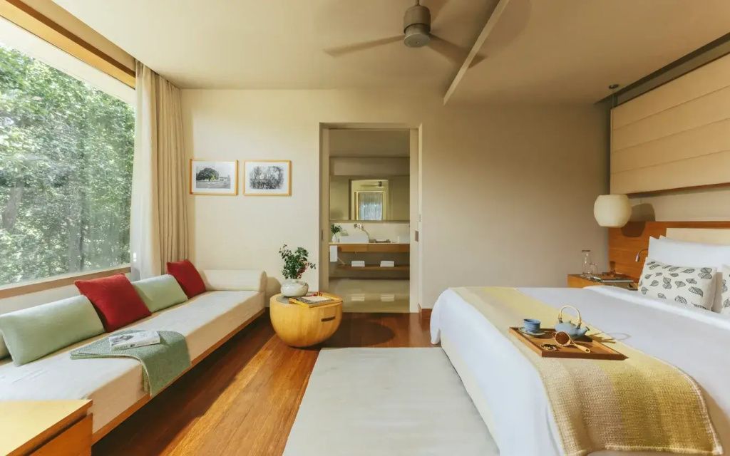 Modern eingerichtetes Standardzimmer mit Holzfußboden und Fensterblick