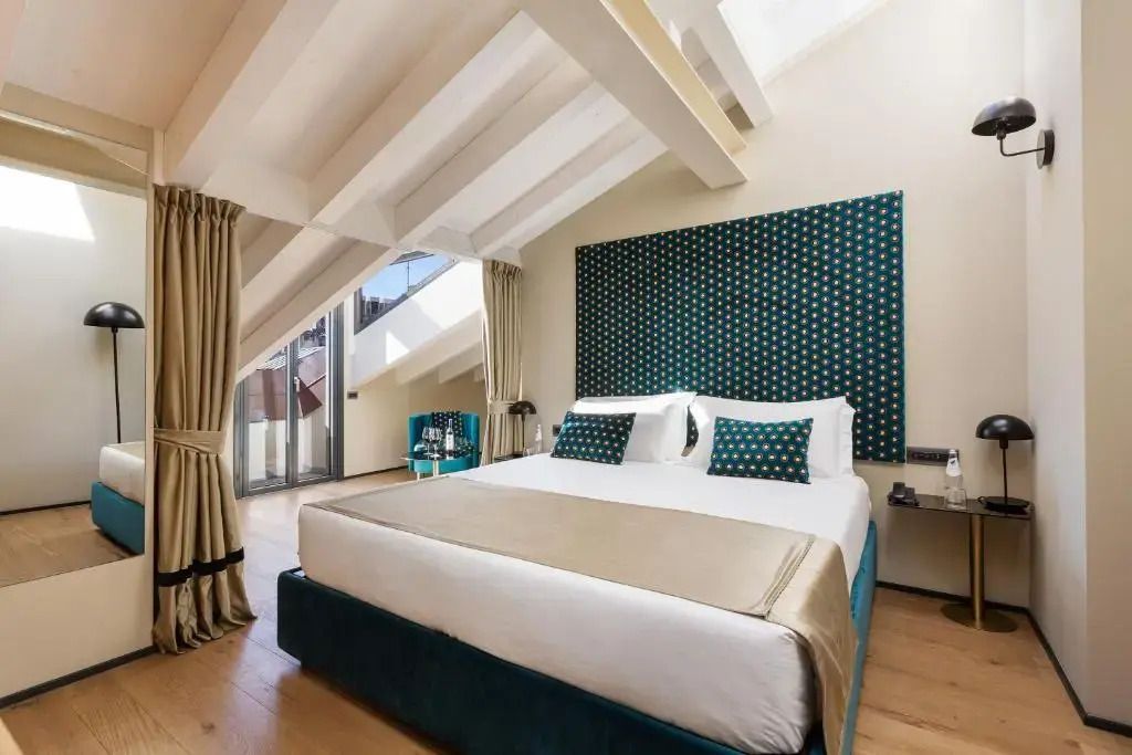 Luxuriöses Schlafzimmer mit schrägen Decken und moderner Einrichtung