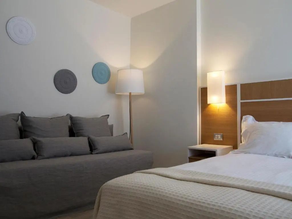 Gemütliches Doppelzimmer mit Sofa und modernen Dekorationen an der Wand