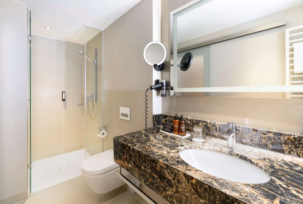 Modernes Badezimmer mit eleganter Marmoroberfläche und großer Dusche