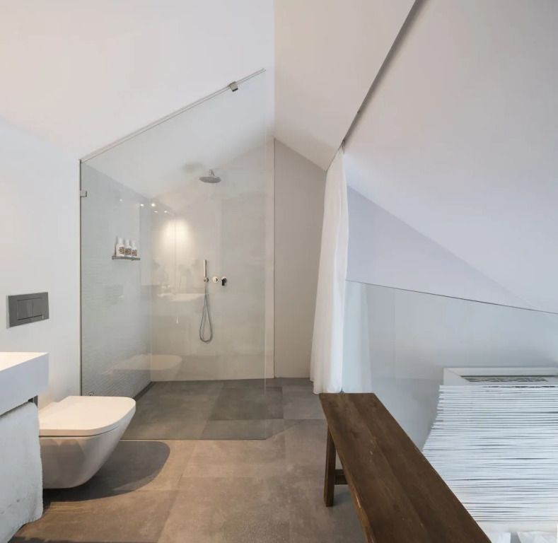 Elegantes Badezimmer mit Glasdusche und moderner Ausstattung in hellen Tönen.