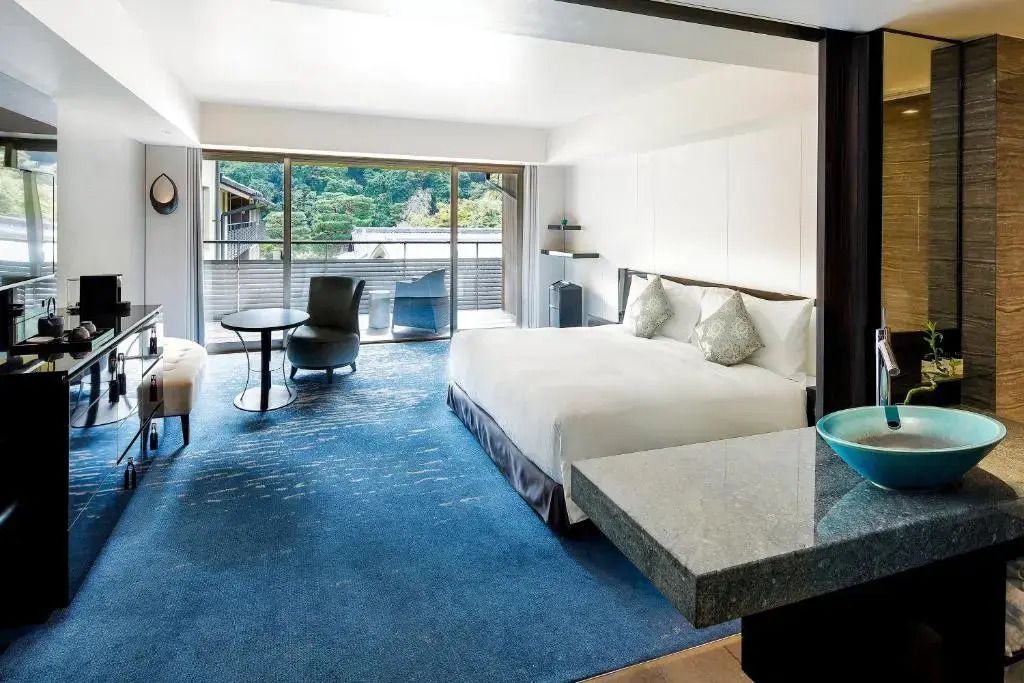 Luxuriöses Doppelzimmer mit modernem Design und großem Fenster zur Terrasse.