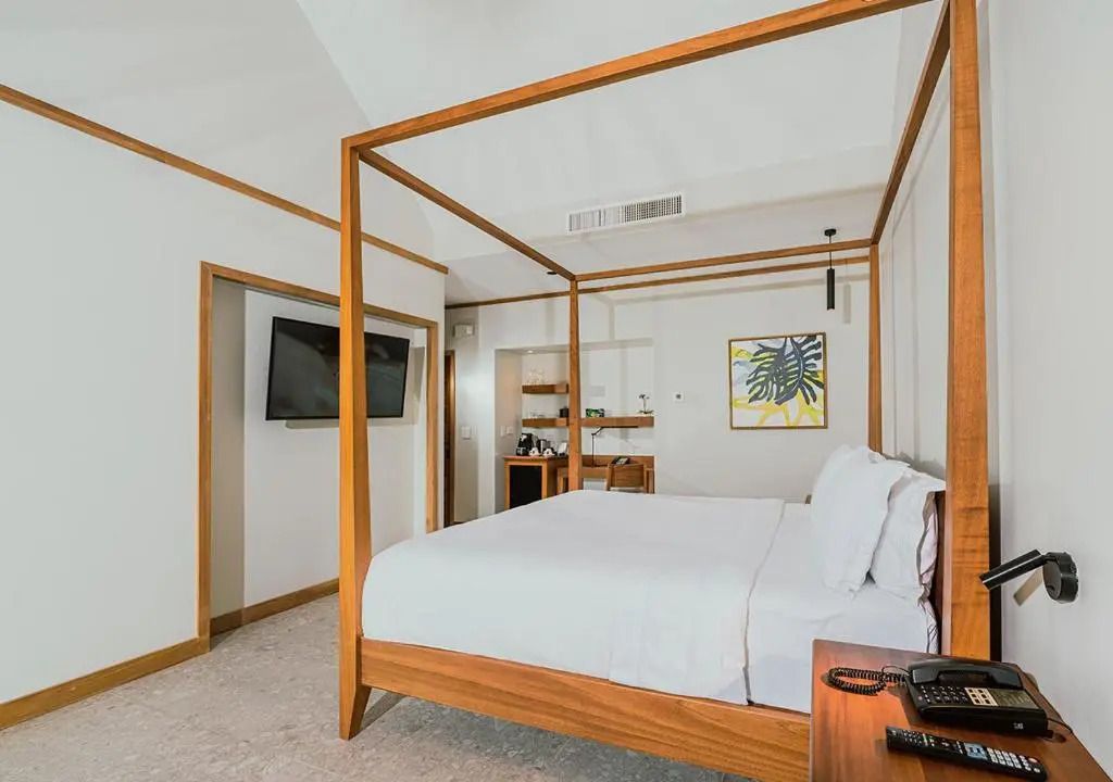 Helles Zimmer mit Himmelbett und minimalistischer Ausstattung