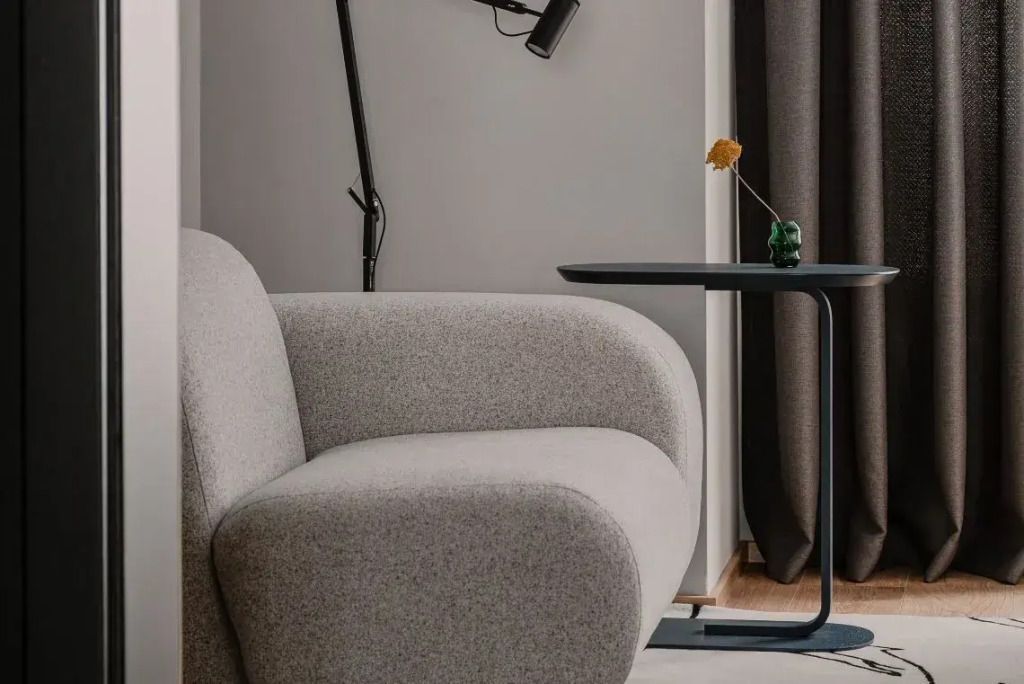 Moderne Sitzecke mit bequemen Sessel und schwarzem Beistelltisch