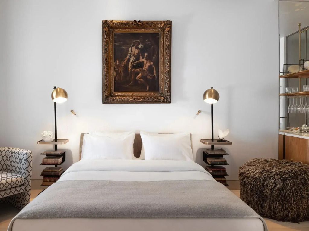 Doppelbett mit eleganten Nachttischen und Kunstwerk an der Wand
