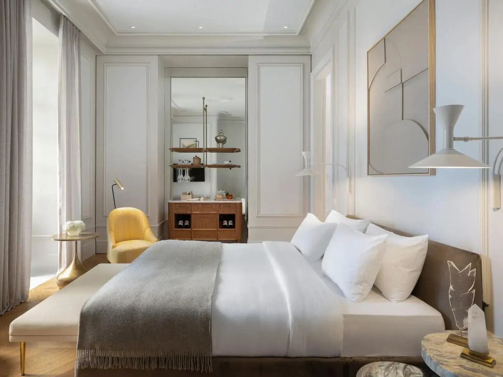 Modernes Doppelzimmer mit Kunstwerk an der Wand und weichen Bettdecken