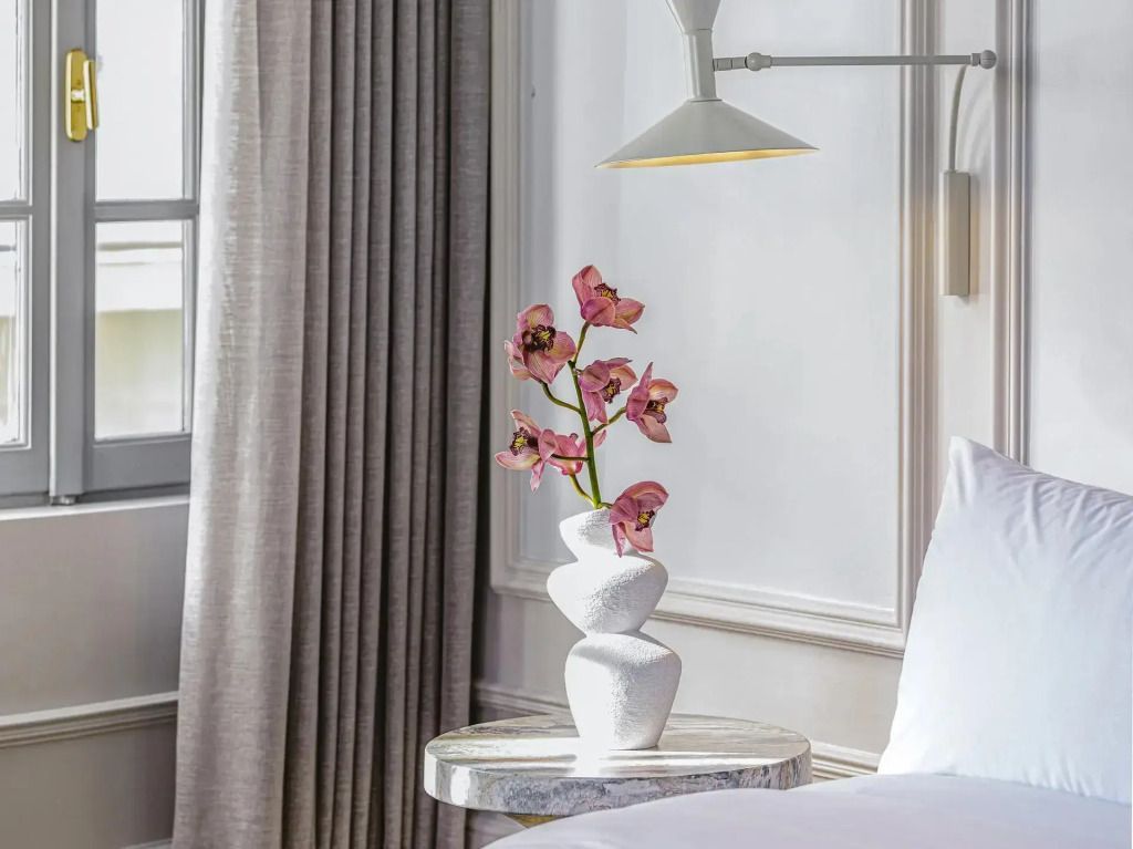 Nahaufnahme eines kunstvoll arrangierten Blumenstraußes auf modernem Tisch in der Suite.