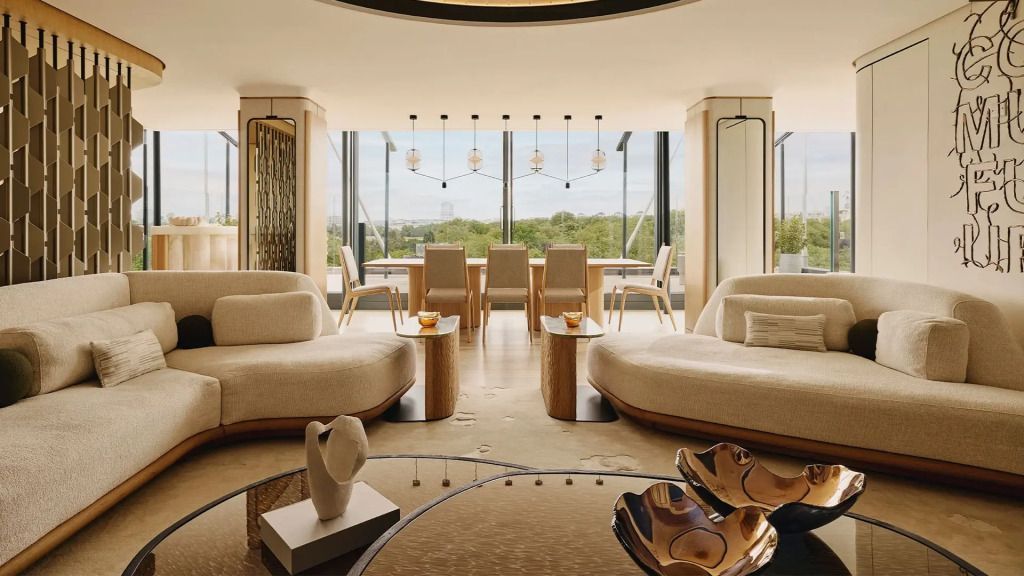 Moderne Lounge mit Designermöbeln und großem Fenster im Penthouse