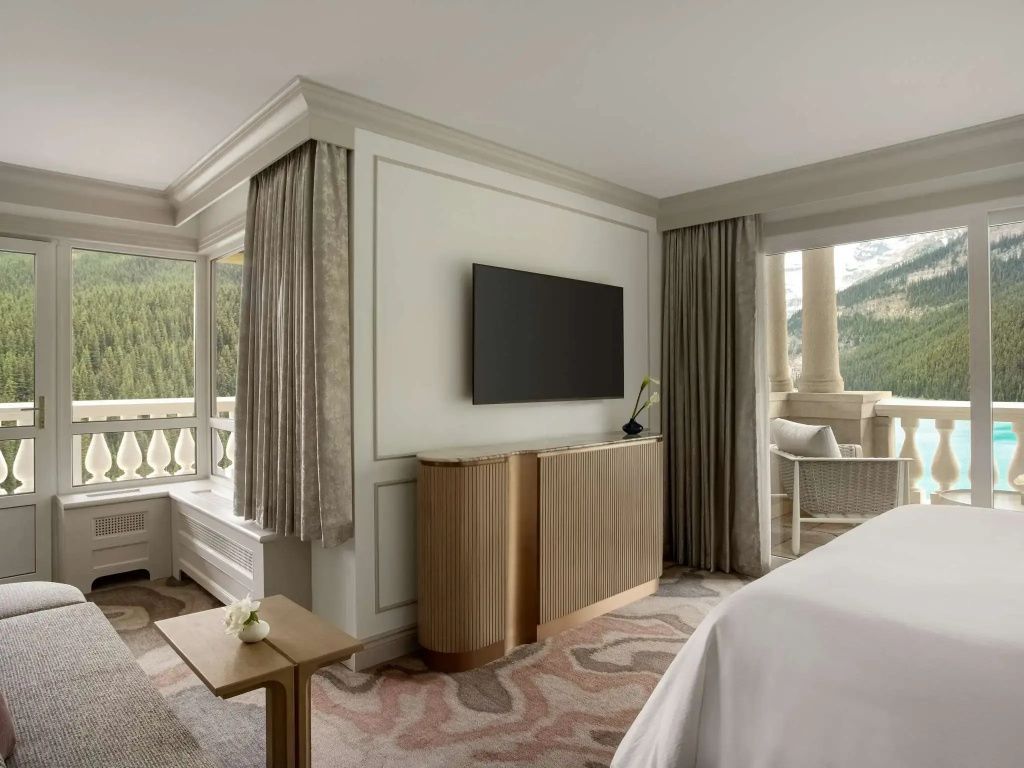 Luxuriös eingerichtetes Schlafzimmer der Belvedere Suite mit Flachbildfernseher und Balkonzugang.